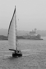 Sailboat Passes By Rose Island Light in the Fog in Rhode Island